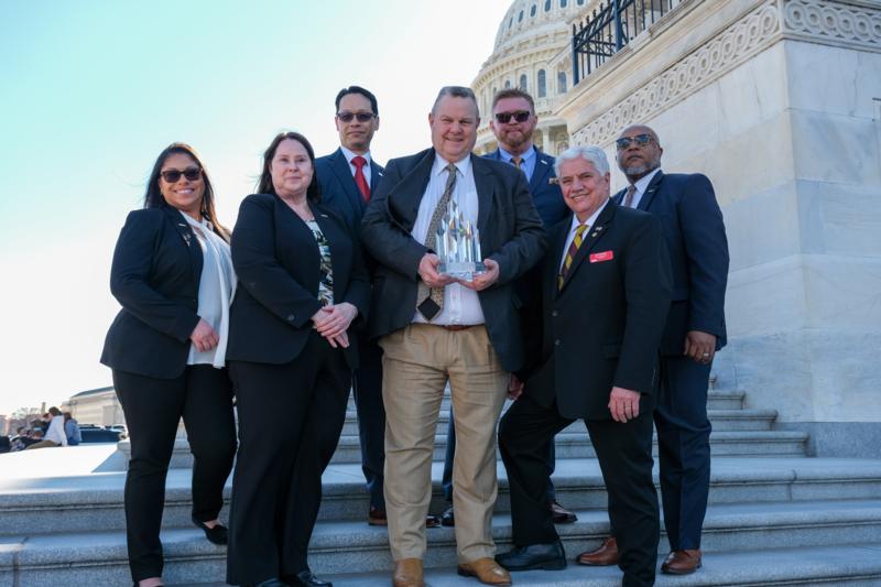 Senator Tester accepting an aware from members of Disabled American Veterans on the Capitol steps.